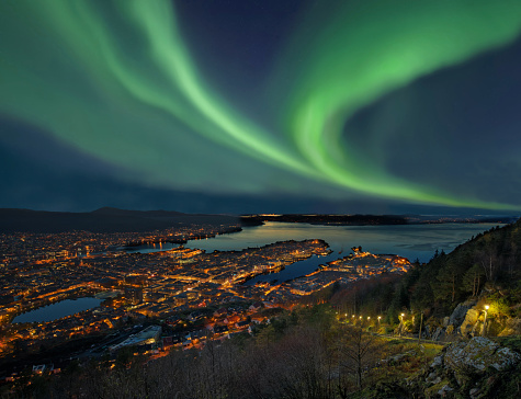 Northern lights - Aurora borealis over harbor of Bergen City, Norway. View from Floyen hill.