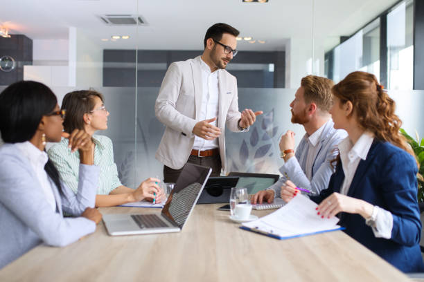istock Businessman explaining business plan to coworkers 689015212