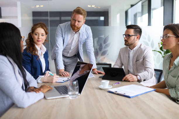 istock Businessman explaining business plan to coworkers 689015382
