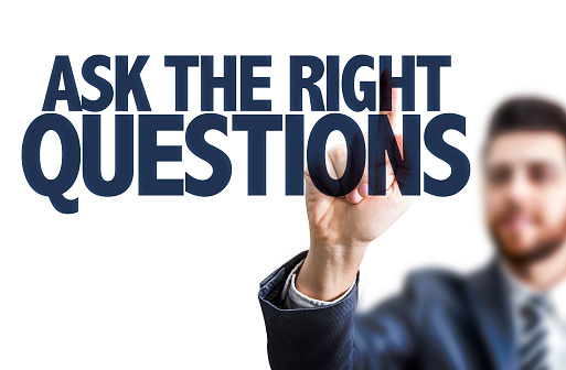 Business man pointing the text: Ask The Right Questions