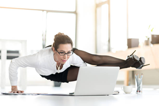 istock Happy woman doing exercises during working day 689022042