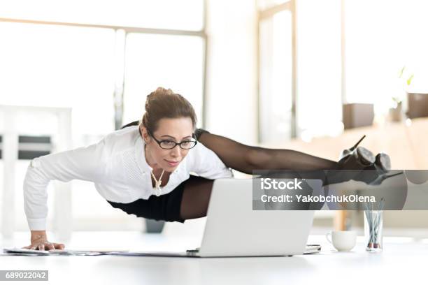 Happy Woman Doing Exercises During Working Day Stock Photo - Download Image Now - Flexibility, Business, Office