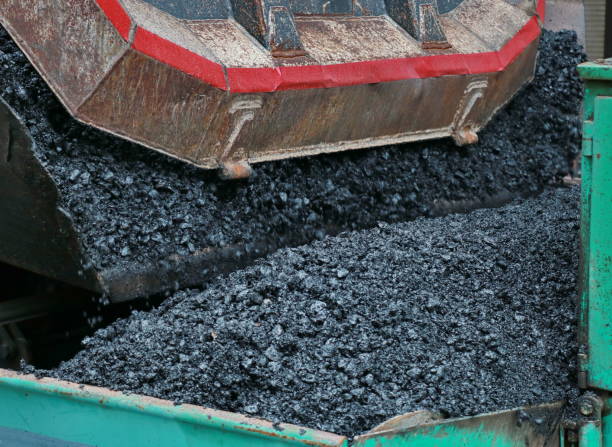 istock Truck unloads asphalt 689022232