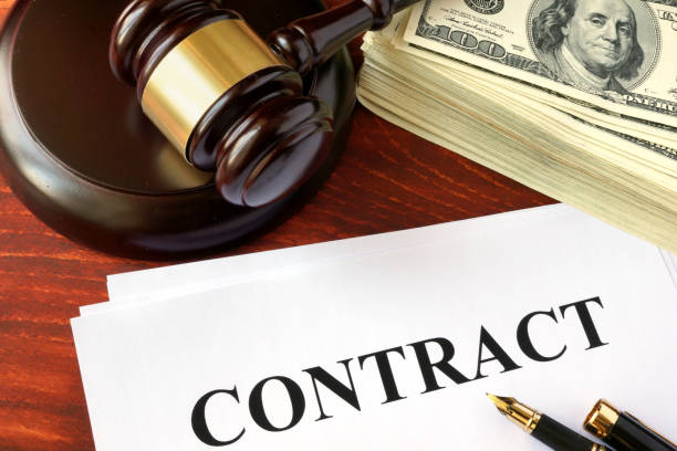 istock Contract, cash and gavel on a wooden surface. 689023190