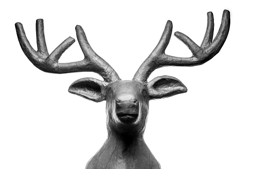 Decorative ebony deer head on an isolated background. Front view. 3d render