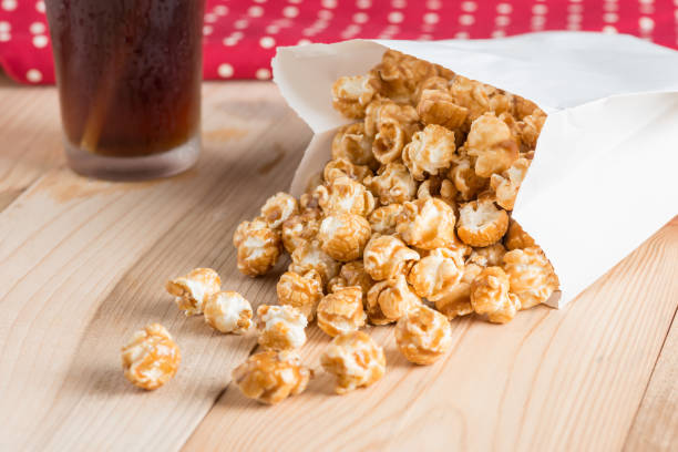 istock Popcorn in bag and coke on table. 689051866