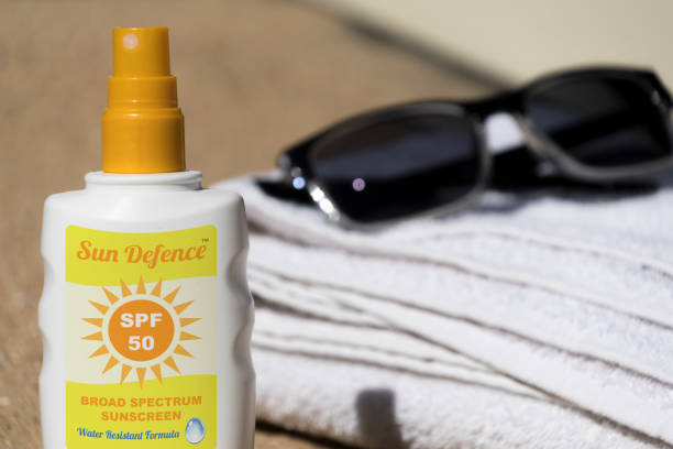 istock Sunscreen, sun tan lotion on the beach with towel 689052044
