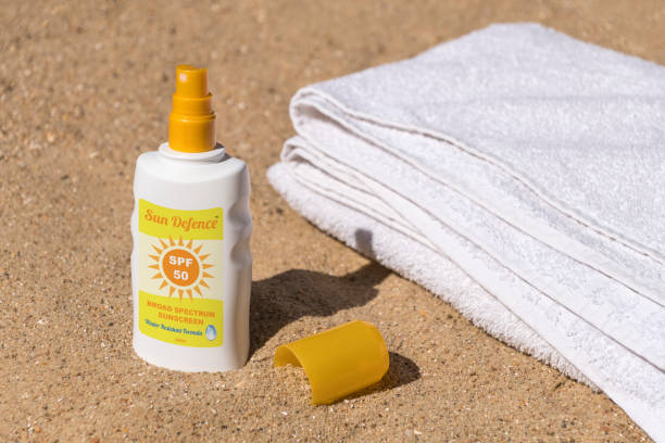 istock Sunscreen, sun tan lotion on the beach with towel 689052050