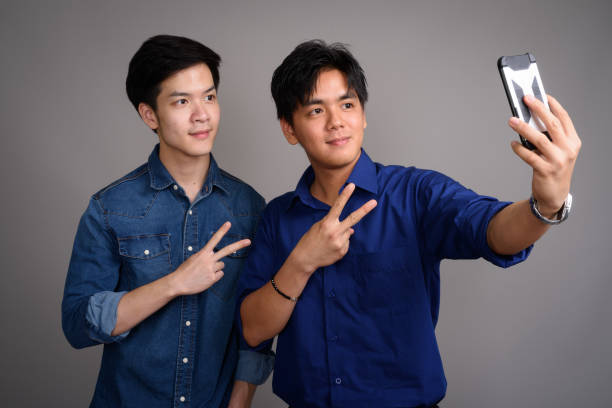 istock Two young man friends together taking selfie with phone 689054544