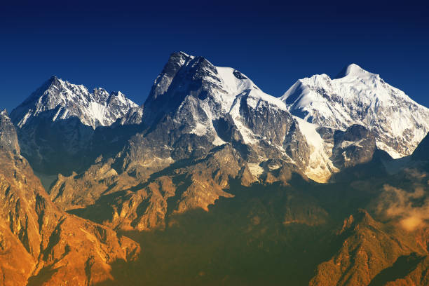 Mount Everest and Lhotse in front of a deep blue sky as seen from next to the Nepalese village Syangboche.