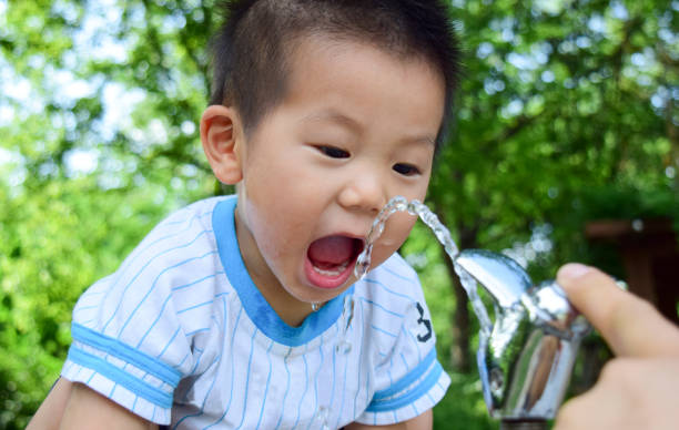istock A child eating tap water in a park 689065726