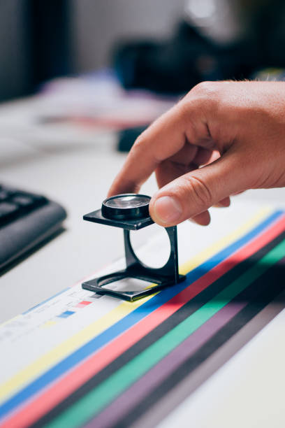 istock Worker in printing and press centar uses a magnifying glass 689065848