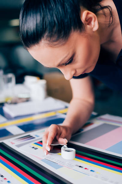 istock Worker in printing and press centar uses a magnifying glass 689068226
