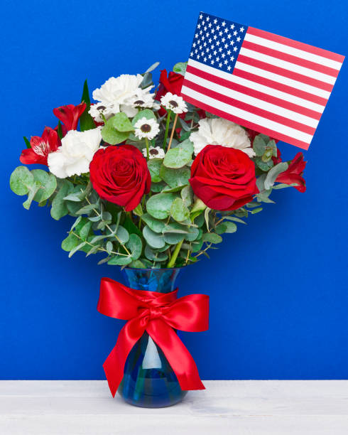 istock Beautiful bouquet with american flag on blue background 689068612