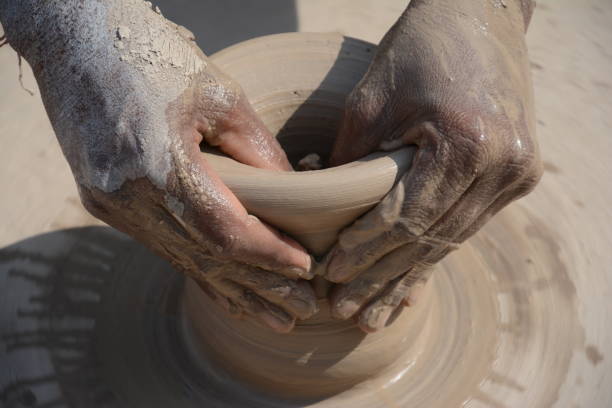 istock Making a clay pottery honey pot on the wheel 689068804