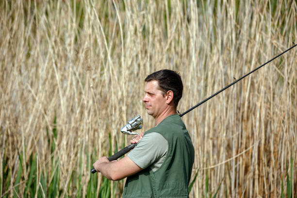 istock Fisherman preparing to cast rod fishing 689069754