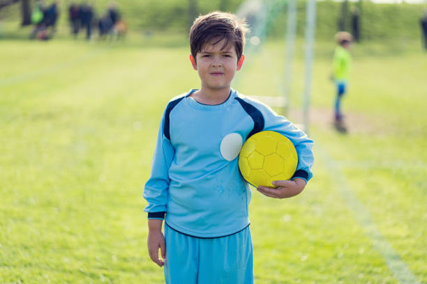 istock Young boy at the stadium playing kids' soccer 689069968