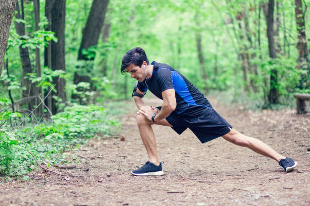 istock Sportsman stretching legs before workout 689070058