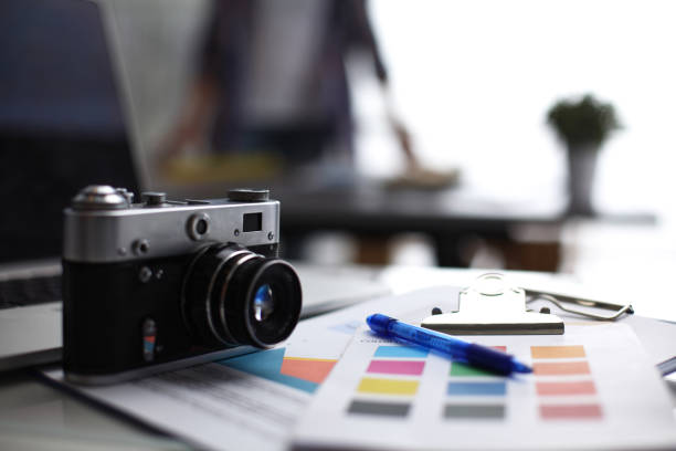 istock Laptop and camera on the desk with folder 689073092