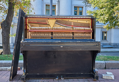 Old piano for street musicians with the front cover removed