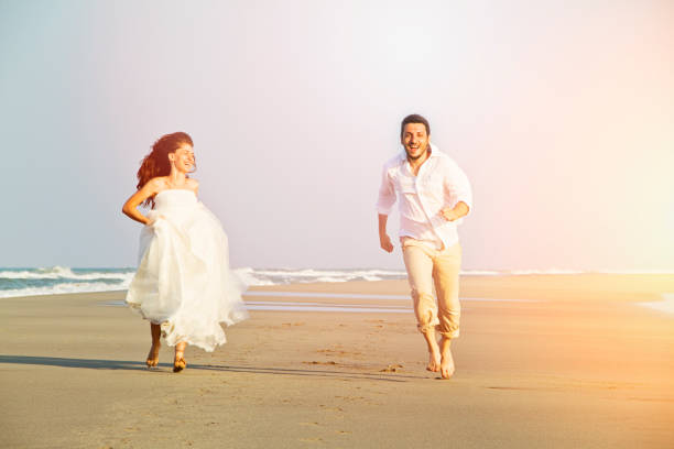 istock Bride and groom at beach 689094710