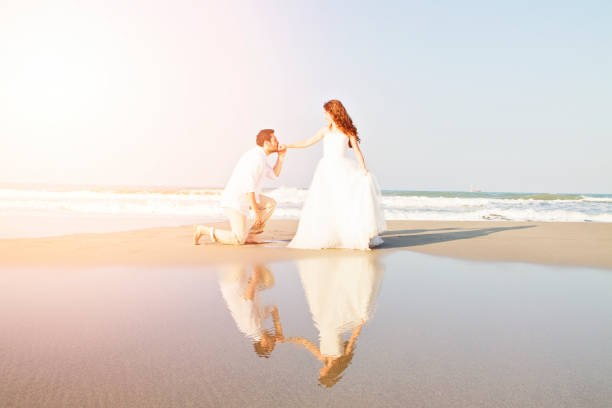 istock Bride and groom at beach 689097844