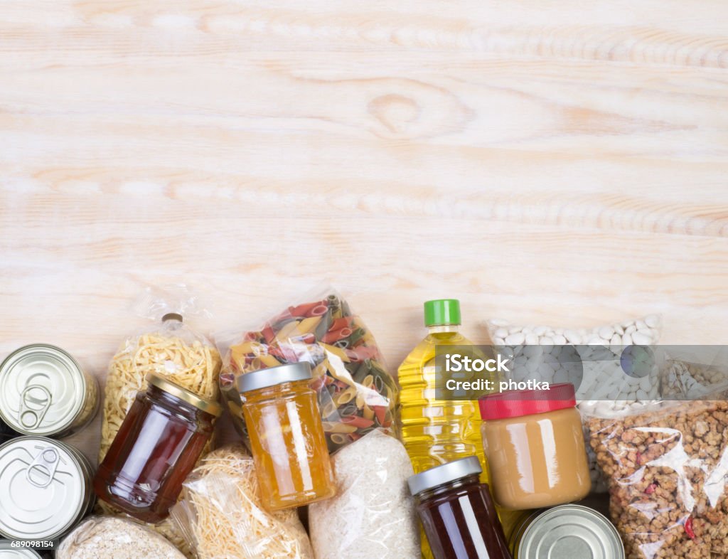 Food donations on wooden background Food samples that can be donated  on wooden background, top view with copy space Food Stock Photo