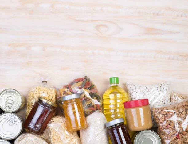 Food donations on wooden background Food samples that can be donated  on wooden background, top view with copy space rice food staple stock pictures, royalty-free photos & images