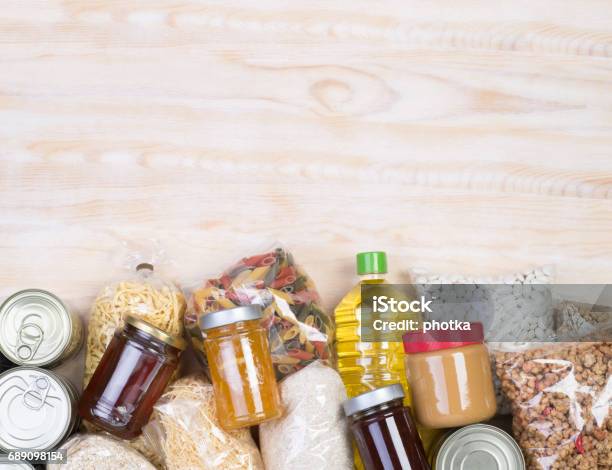 Food Donations On Wooden Background Stock Photo - Download Image Now - Food, Charitable Donation, Canned Food