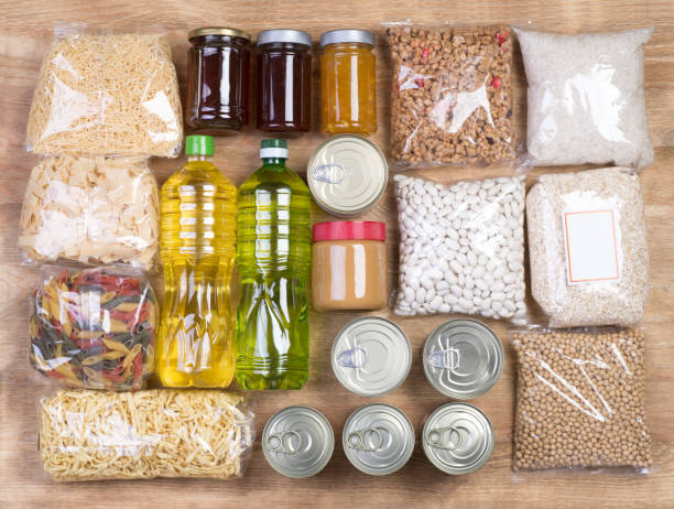 istock Food donations on wooden background 689098202
