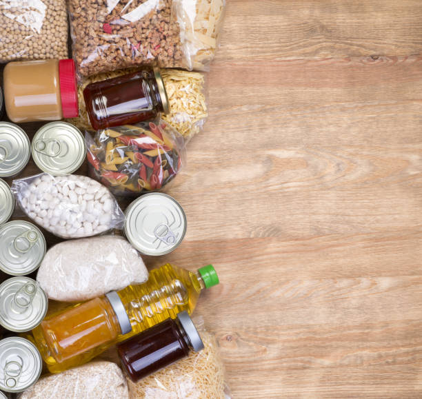 istock Food donations on wooden background 689100260
