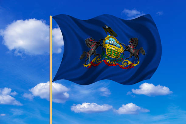 istock Flag of Pennsylvania waving on blue sky background 689100380