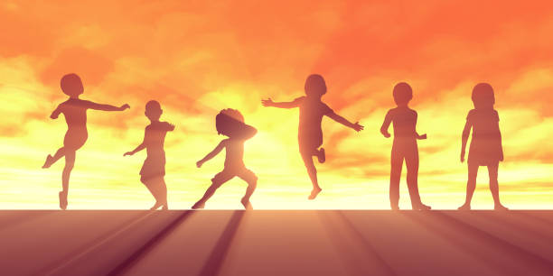 A multi-ethnic group of children are outdoors in a park. They are wearing casual clothing. The kids are jumping up into the air for a fun picture. The sun is setting behind them.