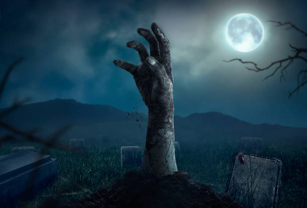 istock Zombie hands rising in dark Halloween night. 689118698