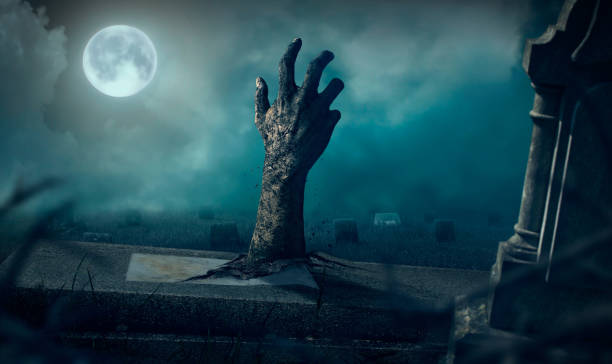 istock Zombie hands rising in dark Halloween night. 689118700