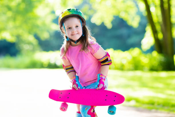 istock Child riding skateboard in summer park 689121802