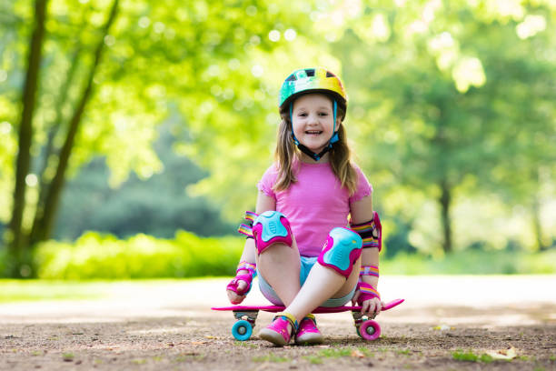 istock Child riding skateboard in summer park 689122036