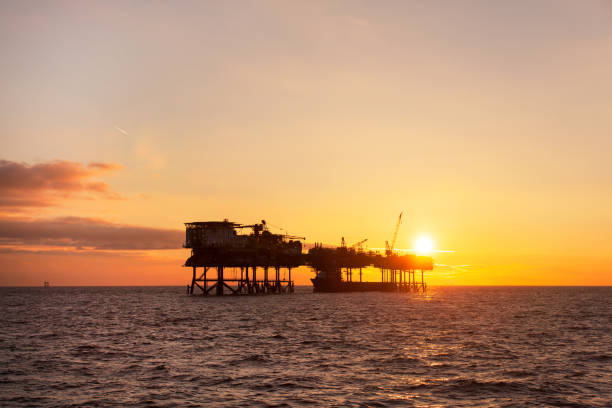 istock An offshore oil installation and a platform supply ship at sunset time 689134538