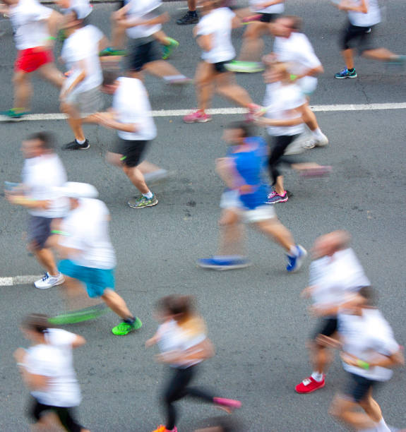People running semi marathon on city streets in attentional motion blur
