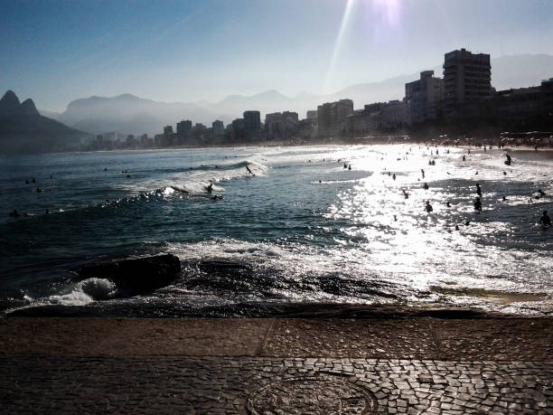 istock Surfing and swimming on copacabana beach, Rio De Janiero 689141860