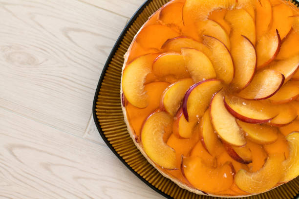 istock Fruit cake with peach, jelly and mousse. 689142348