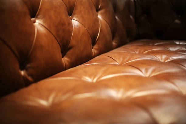 Brown Leather Upholstery Brown Leather Upholstery of Chester Sofa leather couch stock pictures, royalty-free photos & images