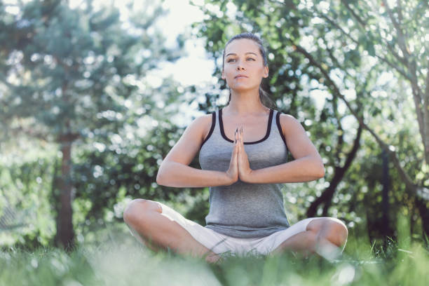 istock Young girl doing yoga in the park 689143666