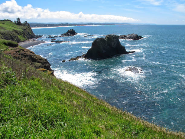 istock Coastal shoreline with jutting rocks and blue waves 689149020