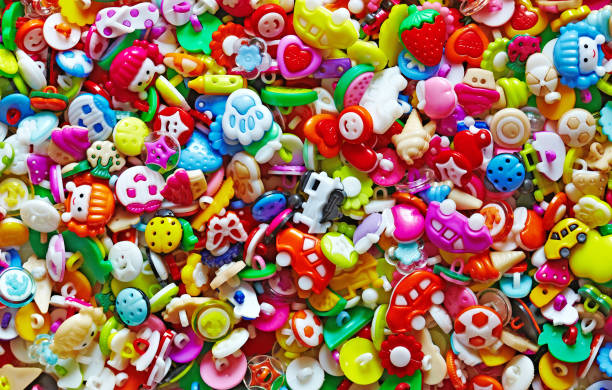 istock Cute sweet shiny colorful pattern background made from  baby buttons 689154340