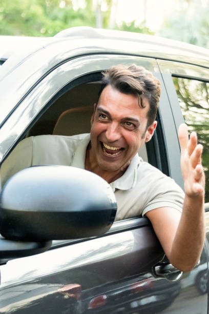 istock Smiling mature man driving his car 689165640