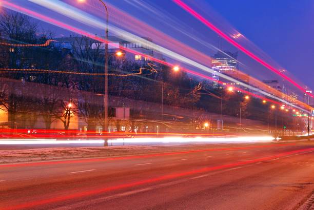 istock Fast moving car light in city at night 689179470
