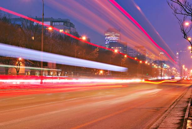 istock Fast moving car light in city at night 689181688