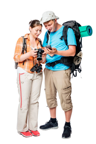 istock Active tourists with backpacks view photos on camera on white background 689182650
