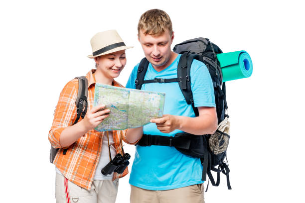 istock Travelers on a hike with a map and backpacks isolated 689182652